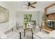 Bright living room with fireplace, ceiling fan, and ample natural light at 1325 Rock Point Rd, Charlotte, NC 28270