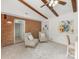 Spacious living room with exposed brick wall and ceiling beams for added character at 1325 Rock Point Rd, Charlotte, NC 28270