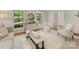 Cozy living room featuring large windows, neutral furniture, and a partial view into an adjacent living space at 1325 Rock Point Rd, Charlotte, NC 28270