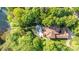 Stunning aerial view of a private home nestled in lush greenery with a backyard pool and lake access at 135 Sumter Dr, Mooresville, NC 28117