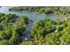Aerial view of a lake house located at 135 Sumter Dr surrounded by mature trees with a private dock and boat slip at 135 Sumter Dr, Mooresville, NC 28117
