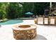 Backyard featuring a custom fire pit and outdoor kitchen by the pool, creating a relaxing retreat at 135 Sumter Dr, Mooresville, NC 28117