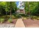 Spacious backyard with a beautiful home and lush greenery, blending nature with luxury at 135 Sumter Dr, Mooresville, NC 28117