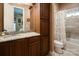Full bathroom featuring dark wood cabinetry, granite countertops, a shower, and a linen closet at 135 Sumter Dr, Mooresville, NC 28117