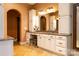 Elegant bathroom vanity with granite countertop, white cabinets and decorative mirror with attractive sconces at 135 Sumter Dr, Mooresville, NC 28117
