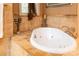 Inviting white soaking tub surrounded by decorative tilework, perfect for a relaxing home spa experience at 135 Sumter Dr, Mooresville, NC 28117