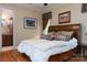 Cozy bedroom with wood floors, decorative artwork, a ceiling fan, and natural light from the window at 135 Sumter Dr, Mooresville, NC 28117