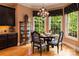 Cozy dining area with chandelier, corner cabinet, black table and chairs, and lots of natural light at 135 Sumter Dr, Mooresville, NC 28117