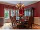 Formal dining room with a large table, elegant chandelier, and custom window treatments at 135 Sumter Dr, Mooresville, NC 28117