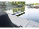 A view of the dock on the lake shows a boat slip and neighborhood homes in the background at 135 Sumter Dr, Mooresville, NC 28117