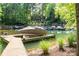 A covered boat sits on a private dock on the lake with a view of the house in the background at 135 Sumter Dr, Mooresville, NC 28117
