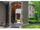 Grand entrance with stone archway, chandelier, and lush landscaping leading to the front door at 135 Sumter Dr, Mooresville, NC 28117