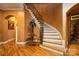 Elegant foyer with a curved staircase, hardwood floors, and decorative accents at 135 Sumter Dr, Mooresville, NC 28117