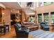 Spacious living room featuring high ceilings, lots of natural light, and stylish leather furniture at 135 Sumter Dr, Mooresville, NC 28117