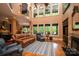 Spacious living room with high ceilings, fireplace, large windows, and elegant furnishings at 135 Sumter Dr, Mooresville, NC 28117