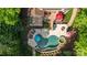 Aerial view of an in-ground pool, hot tub, tanning deck, patio, pergola, outdoor kitchen and firepit at 135 Sumter Dr, Mooresville, NC 28117