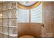 Unique walk-in shower featuring beautiful tilework and glass block walls for added privacy and natural light at 135 Sumter Dr, Mooresville, NC 28117