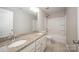 Modern bathroom featuring dual sinks, granite countertops, tub shower combo with tile flooring at 150 Falls Cove Dr, Troutman, NC 28166