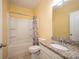 Bathroom with a tub/shower combo, granite countertops, a large mirror, and a tiled floor at 150 Falls Cove Dr, Troutman, NC 28166