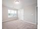 Bedroom featuring carpet flooring, a window providing natural light, and neutral paint at 150 Falls Cove Dr, Troutman, NC 28166