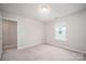 Bedroom offers carpet flooring, a window providing natural light, and a door leading to another room at 150 Falls Cove Dr, Troutman, NC 28166