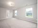 Spacious bedroom with carpet, neutral walls, with ample natural light from the two windows at 150 Falls Cove Dr, Troutman, NC 28166