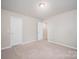 Bedroom features carpet flooring, neutral paint, and 2 doors, offering a versatile layout at 150 Falls Cove Dr, Troutman, NC 28166