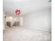 Bonus room featuring carpet flooring, a unique ceiling light fixture, and access to the staircase at 150 Falls Cove Dr, Troutman, NC 28166