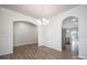 Elegant dining room featuring decorative molding, hardwood floors, and arched doorways at 150 Falls Cove Dr, Troutman, NC 28166