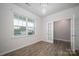 Bright living room with hardwood floors, large window, modern light and glass French doors at 150 Falls Cove Dr, Troutman, NC 28166