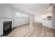 Open-concept living area with a fireplace, hardwood floors, and a breakfast bar at 150 Falls Cove Dr, Troutman, NC 28166