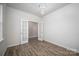 Bright living room with hardwood floors, French doors, and modern light fixture at 150 Falls Cove Dr, Troutman, NC 28166