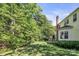 Large, grassy backyard featuring patio seating and mature trees at 15000 Strathmoor Dr, Charlotte, NC 28277