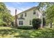 A house exterior and backyard view with green lawn and brick chimney at 15000 Strathmoor Dr, Charlotte, NC 28277