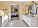 Bathroom with double sinks, and access to bedroom with natural light at 15000 Strathmoor Dr, Charlotte, NC 28277