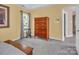 Bedroom featuring neutral colored walls, plush carpet, and a large window with natural light at 15000 Strathmoor Dr, Charlotte, NC 28277