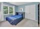Comfortable bedroom with blue walls, a window and a closet at 15000 Strathmoor Dr, Charlotte, NC 28277