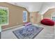 Large bedroom featuring a pink treadmill, a red bean bag chair, and natural light at 15000 Strathmoor Dr, Charlotte, NC 28277