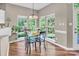 Inviting dining area featuring natural light, wood floors and backyard views at 15000 Strathmoor Dr, Charlotte, NC 28277