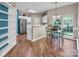 Bright dining area with wood floors, ample natural light, and view to open kitchen and living area at 15000 Strathmoor Dr, Charlotte, NC 28277