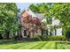 Charming two-story home with brick and vinyl siding, manicured lawn, and mature landscaping at 15000 Strathmoor Dr, Charlotte, NC 28277