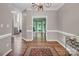 Wide hallway with hardwood floors leading to a staircase and an office space with a bay window at 15000 Strathmoor Dr, Charlotte, NC 28277