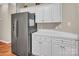 Kitchen features a stainless steel refrigerator, white cabinets and countertops with modern amenities at 15000 Strathmoor Dr, Charlotte, NC 28277