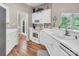 Bright kitchen with white cabinets, stainless steel appliances, and modern countertops and wood flooring at 15000 Strathmoor Dr, Charlotte, NC 28277