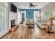 Bright living room featuring fireplace, hardwood floors, large windows and comfortable couches at 15000 Strathmoor Dr, Charlotte, NC 28277