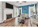 Bright living room with fireplace, hardwood floors, and large windows with white curtains at 15000 Strathmoor Dr, Charlotte, NC 28277