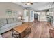 Spacious living room with wood floors, neutral paint, and open floor plan, with an adjacent kitchen/dining area at 15000 Strathmoor Dr, Charlotte, NC 28277