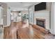 Open-concept living space with a cozy fireplace and views into the kitchen and dining areas at 15000 Strathmoor Dr, Charlotte, NC 28277