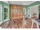 Bright and airy office space with built-in bookshelves, a ladder, hardwood floors, and large windows at 15000 Strathmoor Dr, Charlotte, NC 28277