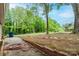 Open backyard space with brick elements and lots of trees at 1521 19Th Sw St, Hickory, NC 28602